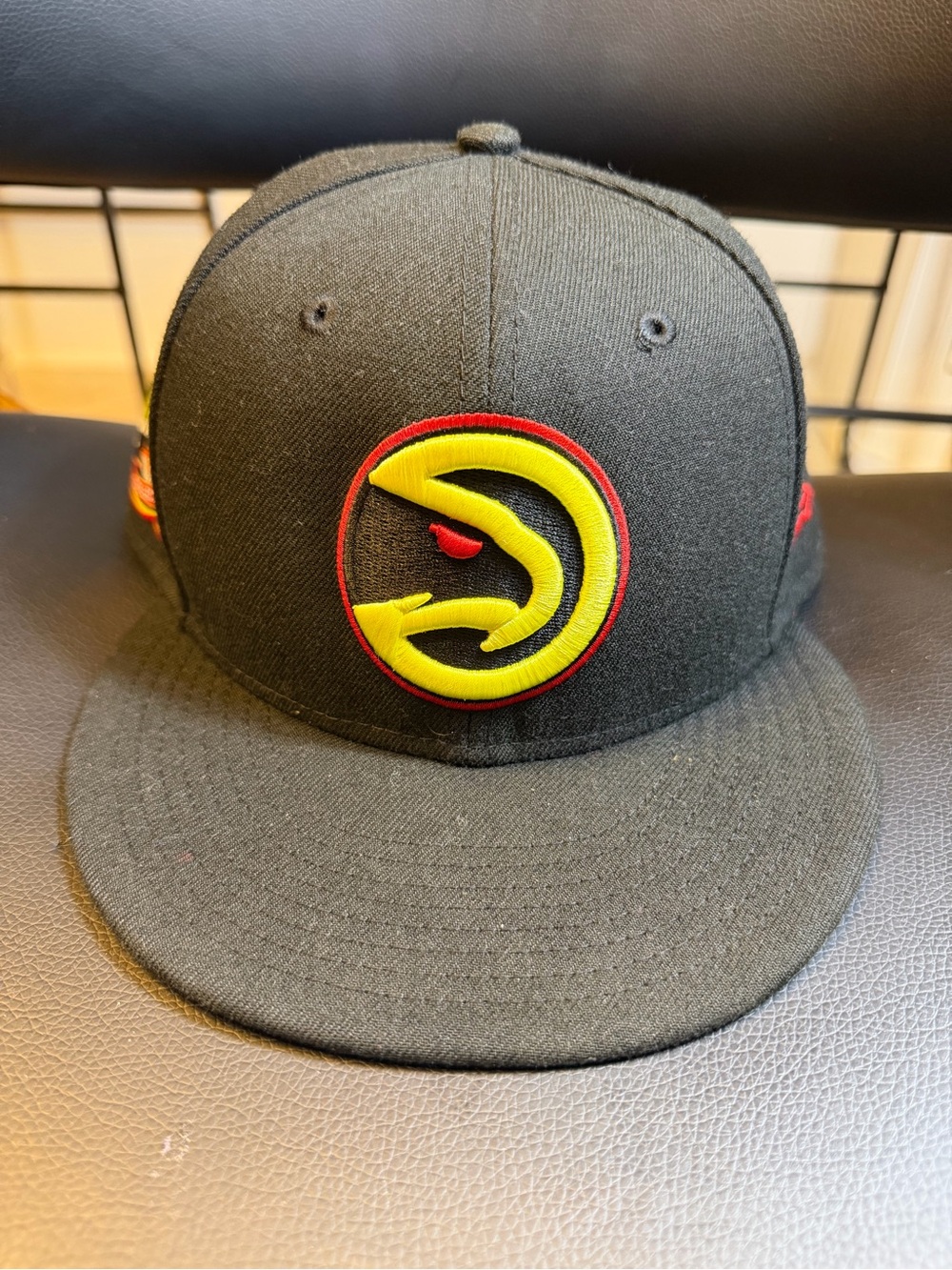 New Era Black Snapback Hat with Yellow & Red Hawk Emblem